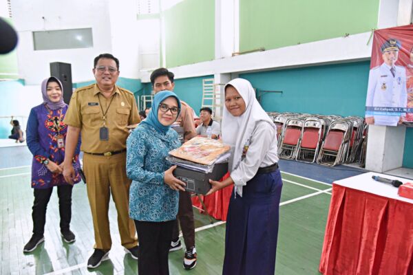 Ketua TP PKK Surabaya Rini Indriyani Eri Cahyadi saat memberikan seragam sekolah gratis kepada para pelajar/Dok. Diskominfo Surabaya