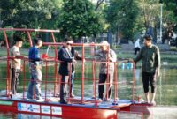 Rektor ITS Prof Dr (HC) Ir Bambang Pramujati ST MScEng PhD (berjas) bersama tim peneliti Kapal Pembersih Sampah Tanpa Awak melakukan uji coba kapal di danau Infinits ITS. (Foto: dok Humas ITS)